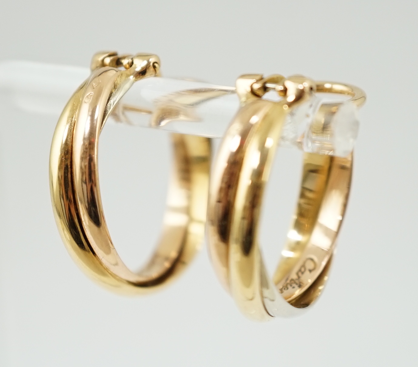 A pair of French Cartier three colour 18ct gold interwoven hoop ear clips